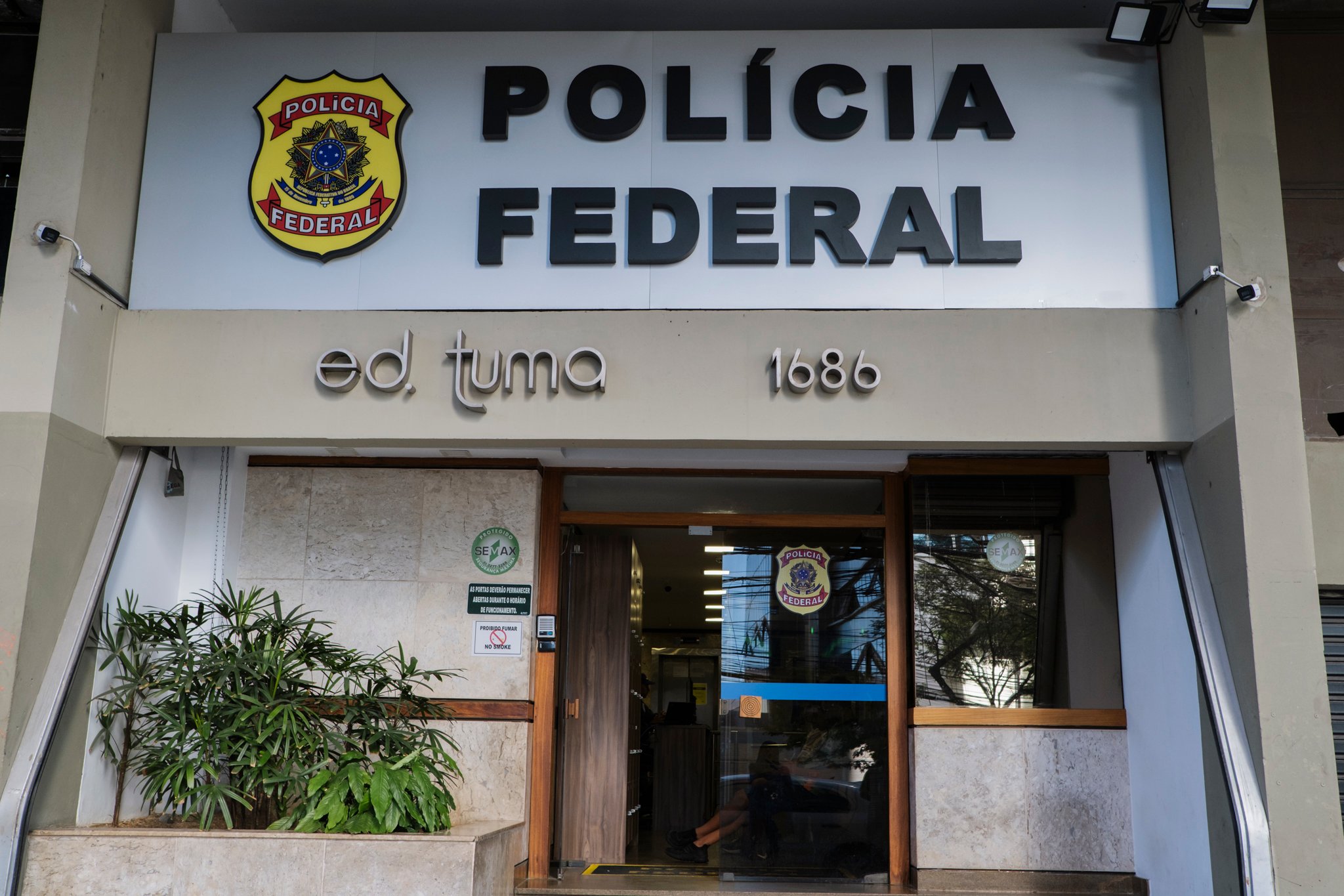 Street-level entrance of Polícia Federal office in Belo Horizonte with shield logo and building number 1686.