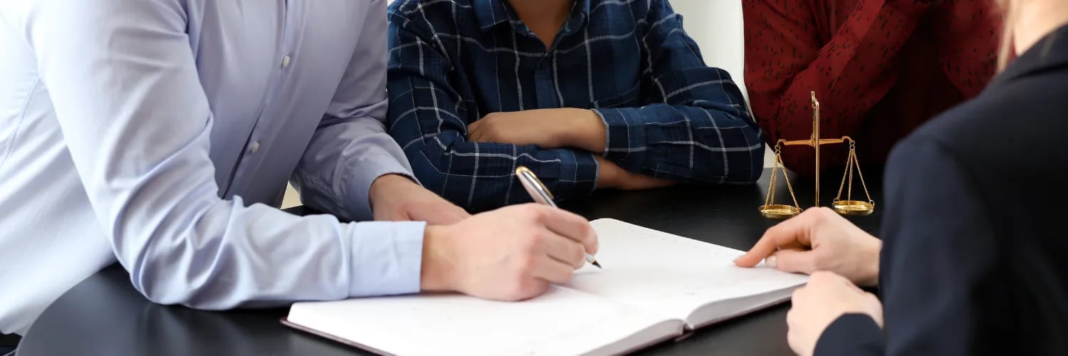 Brazilian legal consultation with clients reviewing documents for cross-border family, inheritance, and property matters.