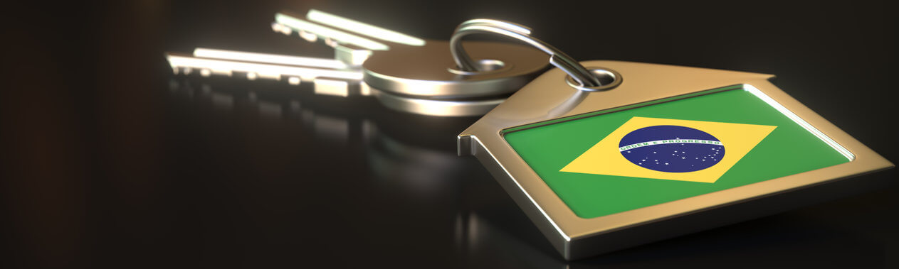 Flag of Brazil on the keychain and keys. Property rental or real estate market concepts, 3d rendering