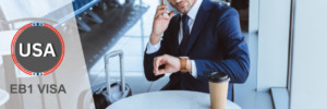 Businessman checking his watch and making a call, representing an EB1 visa holder's travel readiness.