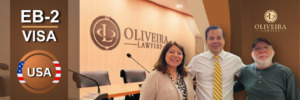 Attorney with clients celebrating EB-2 Visa success.