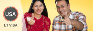 Smiling couple giving a thumbs-up for L1 Visa approval