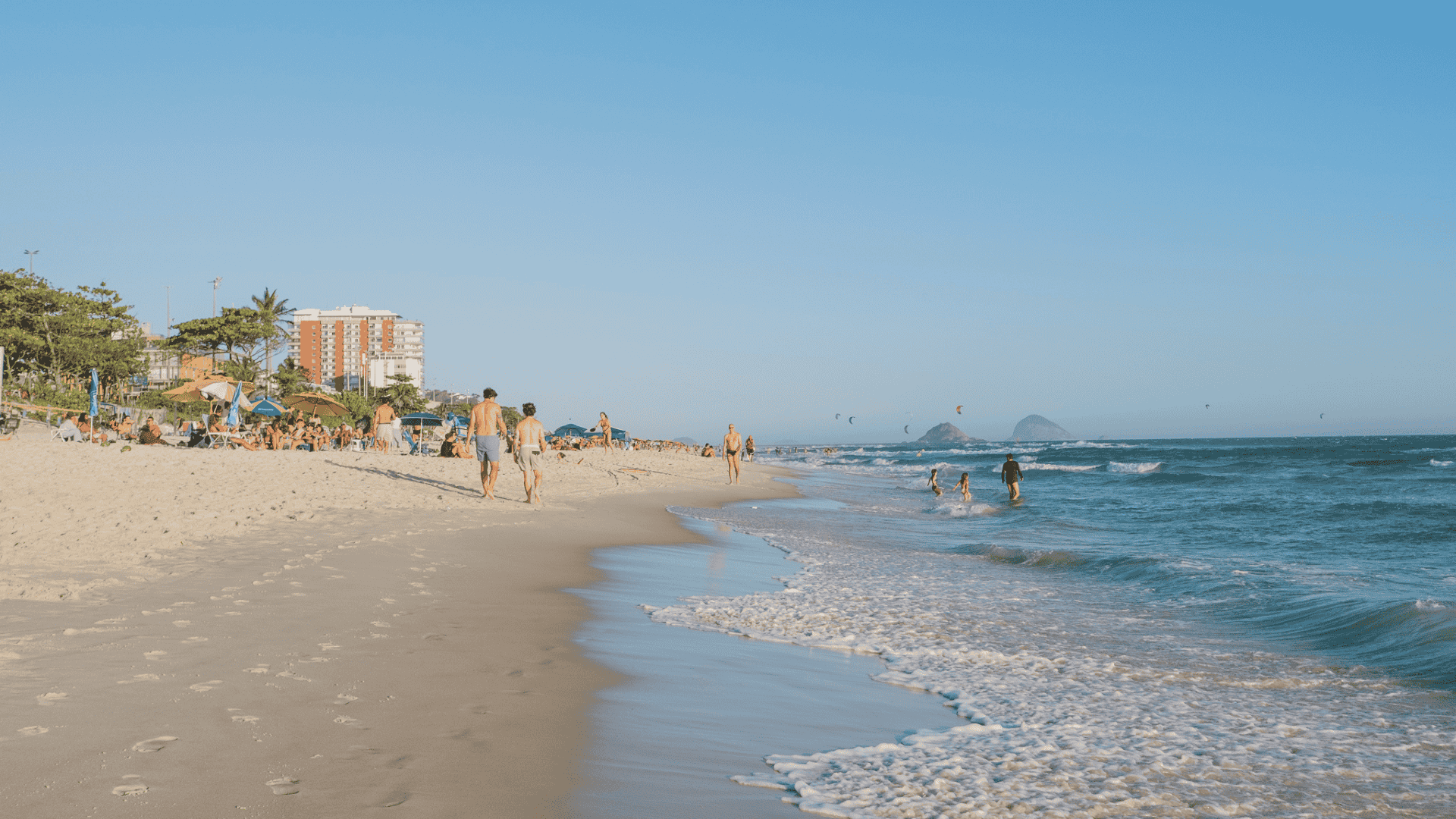 Beachgoers enjoying a sunny day at Barra da Tijuca beach, in Rio de Janeiro